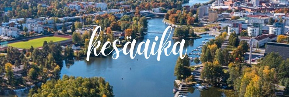 Ilmakuva Valkeakosken keskustan maisemista. Kuvassa on järvi, saari, puustoa sekä kaupungin erilaisia rakennuksia kuvattuna ilmasta käsin.